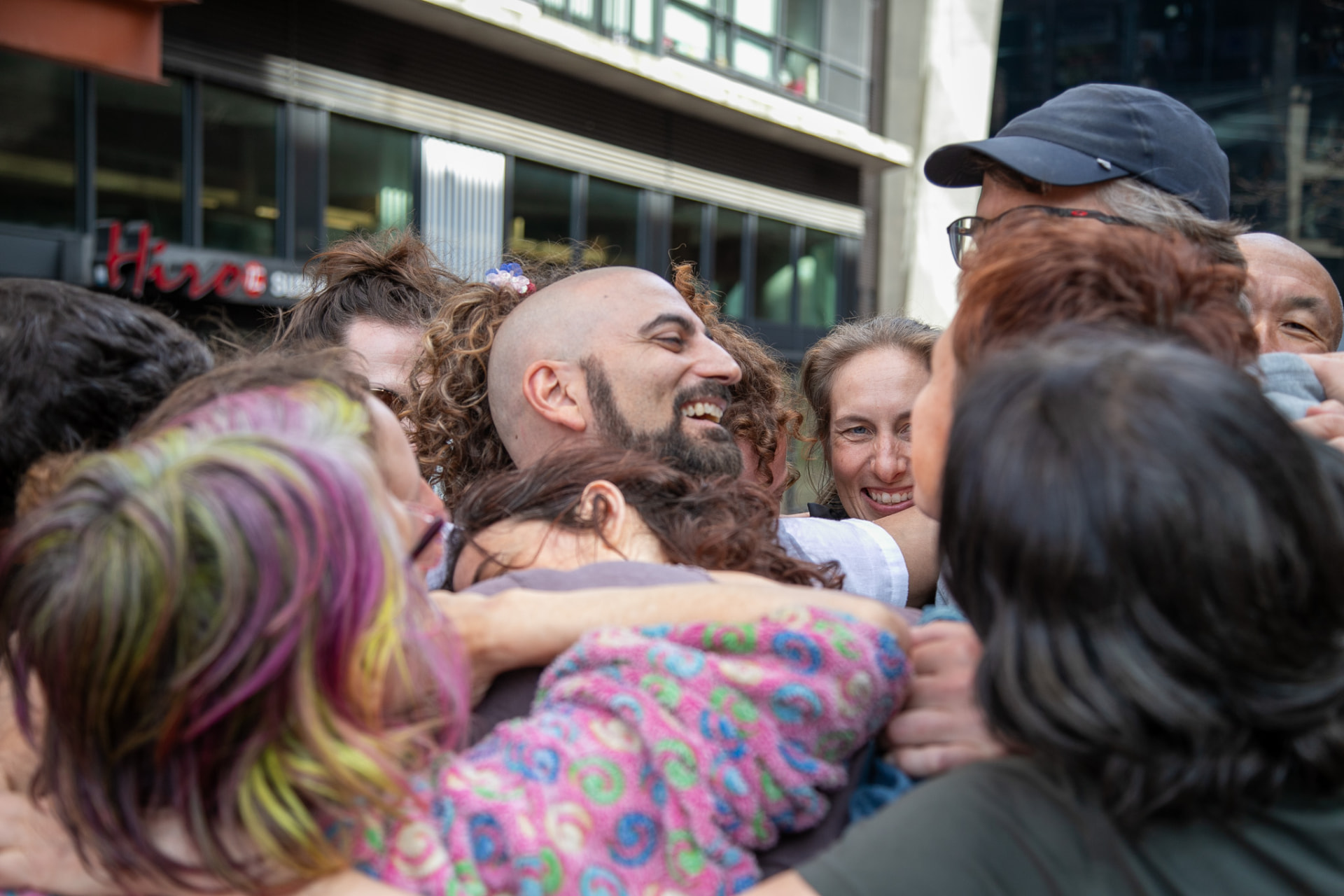 Group embrace after the closing jam
