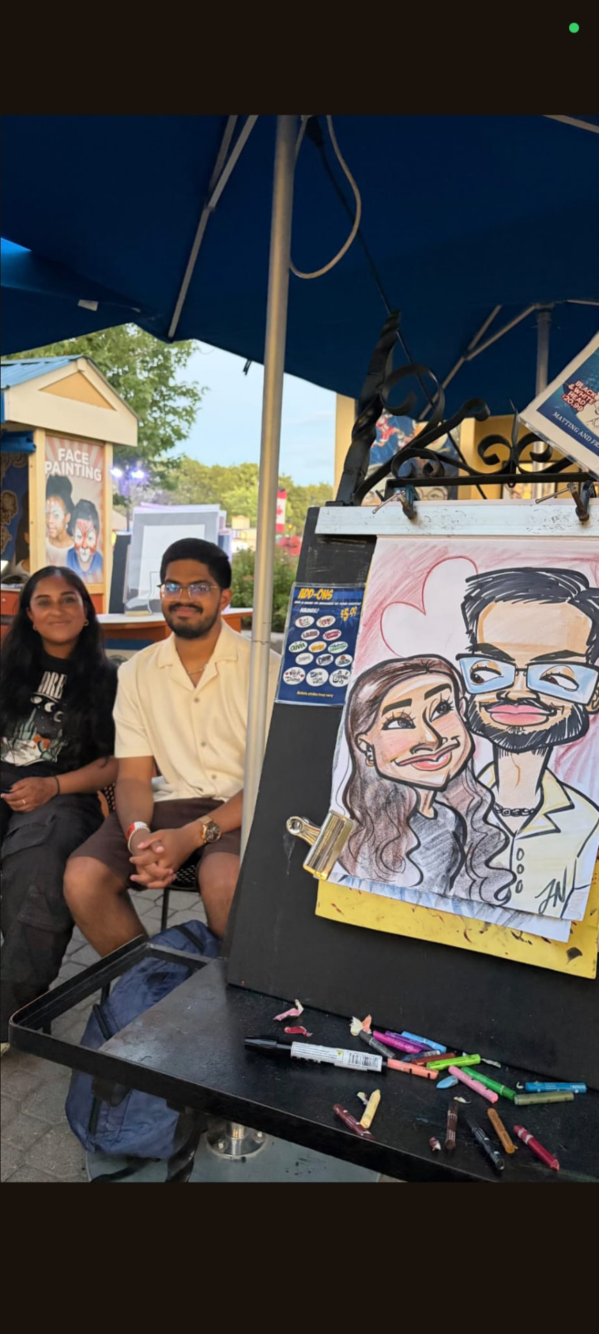 Guests posing with their finished caricature at a theme park