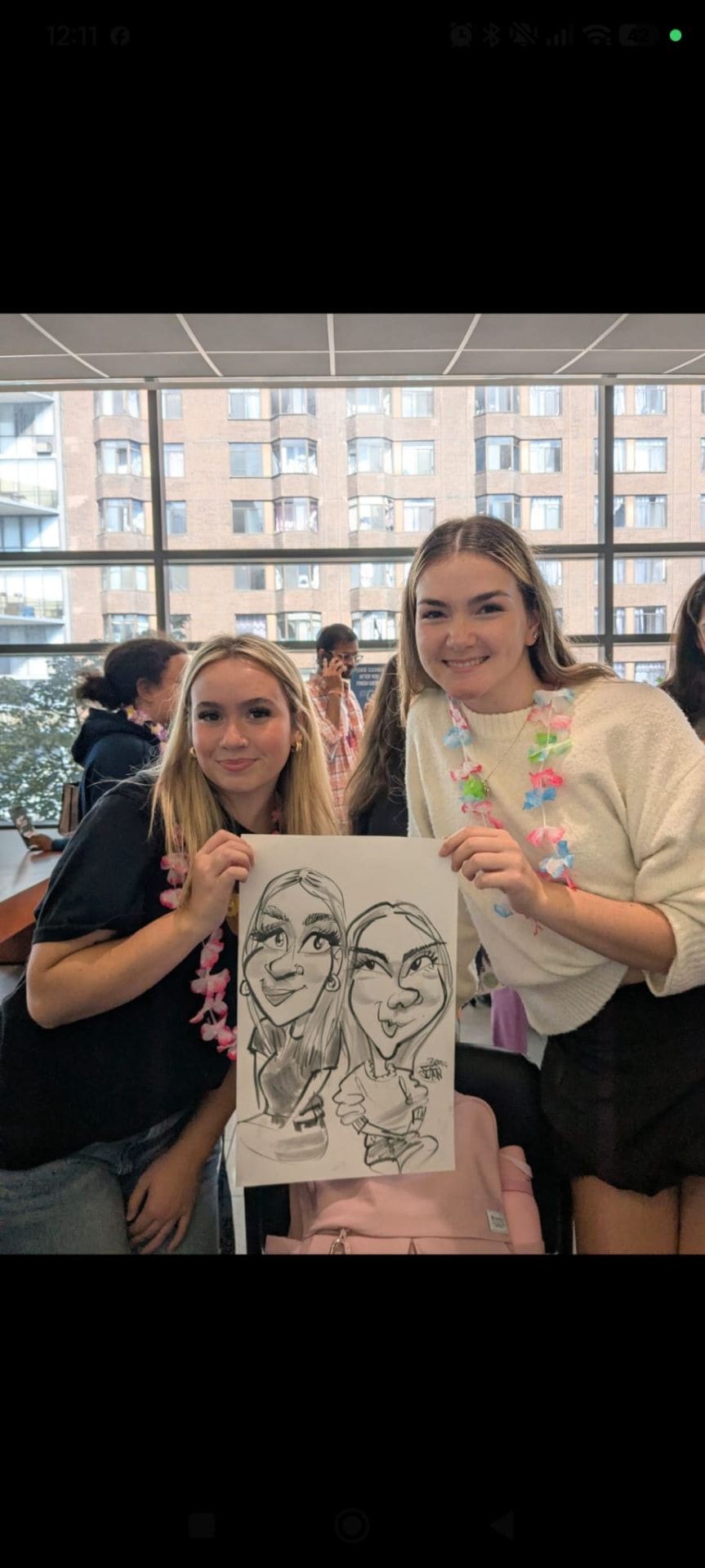 Students holding a live black and white duo caricature