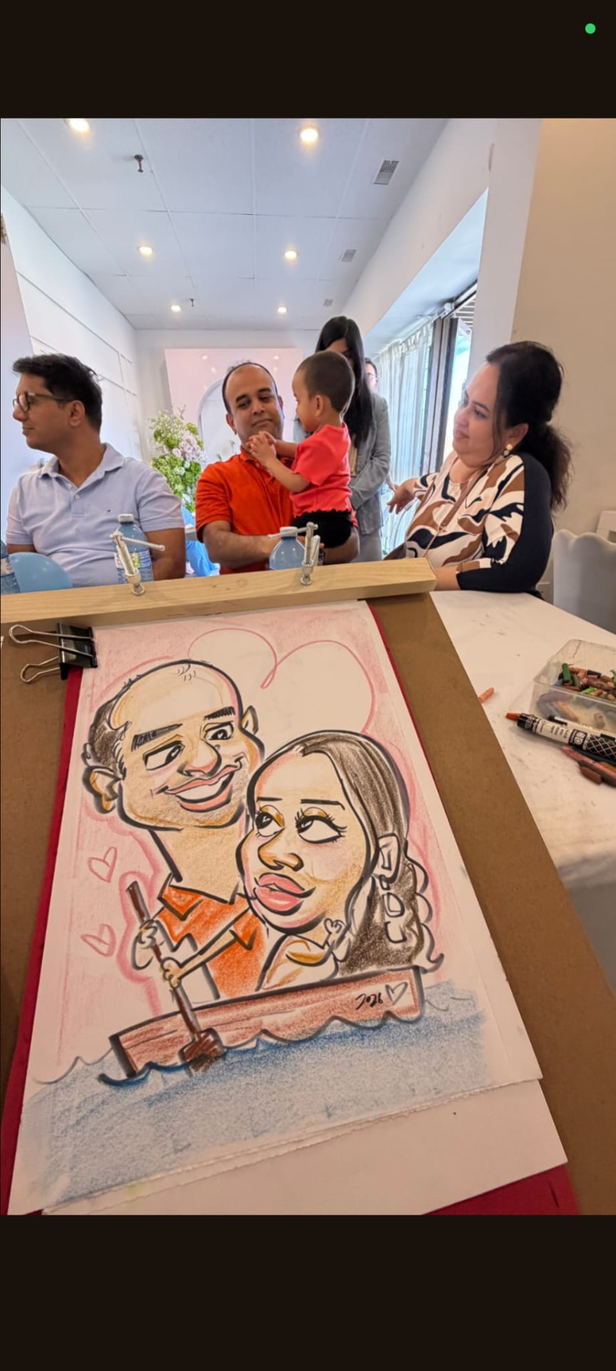 Couple caricature in a rowboat drawn live at an event
