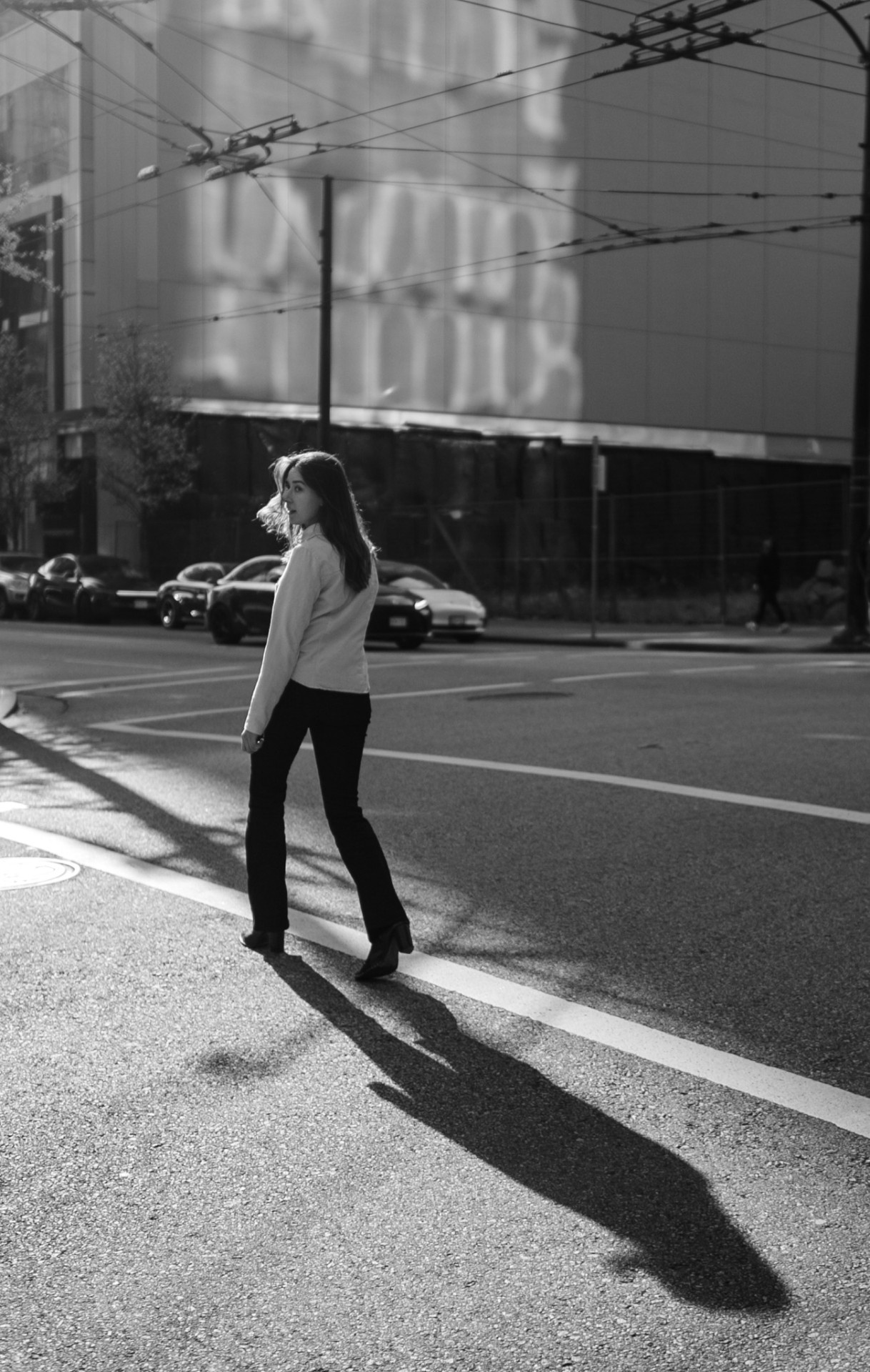 Crossing the street — long shadow, hard afternoon sun
