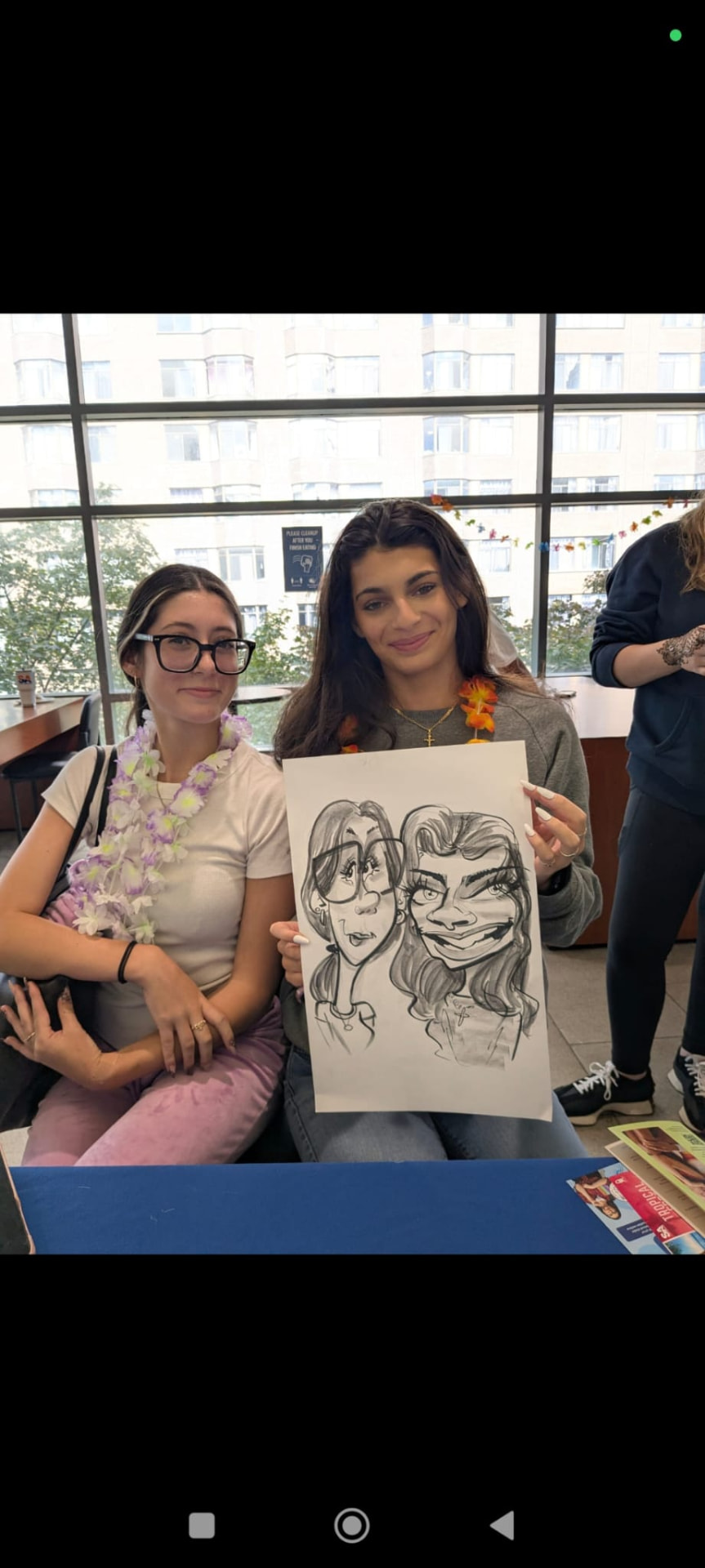 Two guests with their charcoal caricature drawn on site